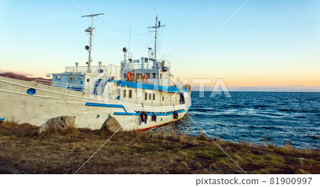 The ship is moored on the shore of Lake Baikal. Autumn landscape. The nature of Eastern Siberia. At sunset. 81900997