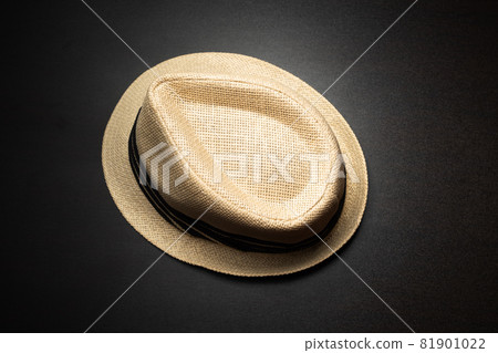 A brown hat is placed on a black table. A brown hat is placed on a black table. 81901022