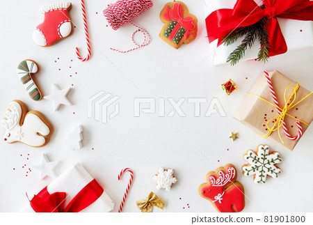 Christmas frame. Winter holidays background. New Year postcard. Gift box candy cane gingerbread biscuit colorful festive decoration round border isolated on white copy space. Christmas frame. Winter holidays background. New Year postcard. Gift box candy cane gingerbread biscuit colorful festive decoration round border isolated on white copy space. 81901800