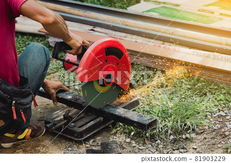 Worker man cutting steel with a circular steel cutter. Worker man cutting steel with a circular steel cutter. 81903229