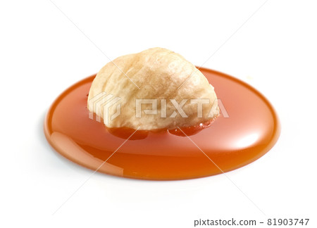 hazelnut in melted caramel drop hazelnut in melted caramel drop 81903747