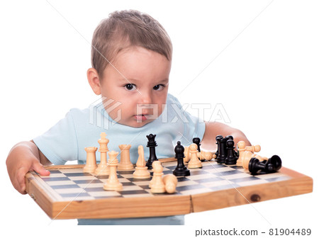 little boy staring at the chess pieces isolated on white background 81904489