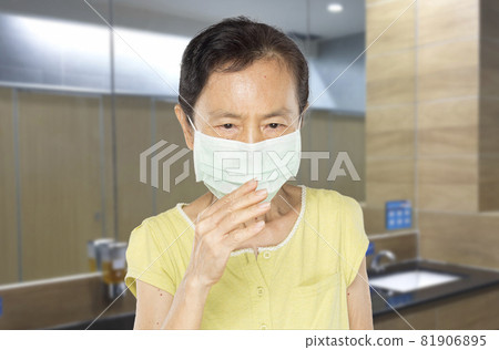 woman wearing a virus mask worried about covid-19 81906895