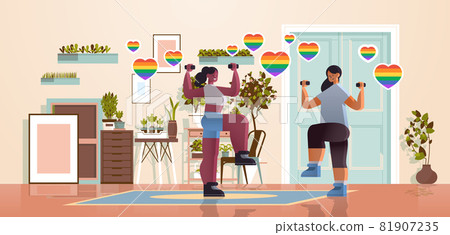 mix race girls lovers doing physical exercises with dumbbells lesbian love parade transgender LGBT concept mix race girls lovers doing physical exercises with dumbbells lesbian love parade transgender LGBT concept 81907235