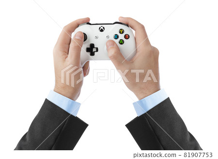 Moscow, Russia - April 18, 2019: Hands and wireless Xbox console gamepad - isolated on white background Moscow, Russia - April 18, 2019: Hands and wireless Xbox console gamepad - isolated on white background 81907753