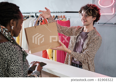 Salesman selling clothes to customer Salesman selling clothes to customer 81908322
