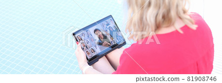 Young woman is holding online business conference via tablet while sitting on edge of pool Young woman is holding online business conference via tablet while sitting on edge of pool 81908746
