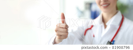Female doctor demonstrating thumbs up gesture closeup 81908796