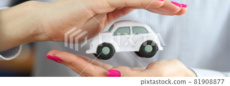 Inside female hands is white small car Inside female hands is white small car 81908877