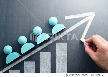 Teamwork and productivity. Hands drawing graphs and arrows on four humanoid blocks and a blackboard. Teamwork and productivity. Hands drawing graphs and arrows on four humanoid blocks and a blackboard. 81909179