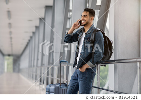 Roaming Abroad. Portrait Of Handsome Arab Man Talking On Cellphone In Airport 81914521
