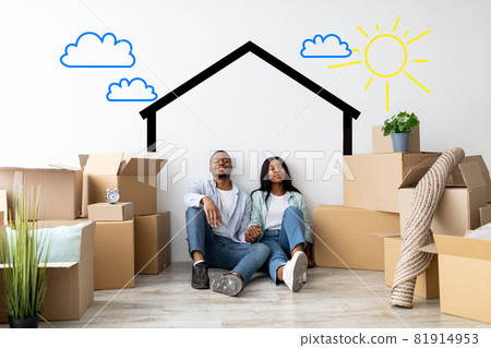 Loving african american spouses relocating to their home, dreaming about renovation, sitting near wall with drawn house 81914953