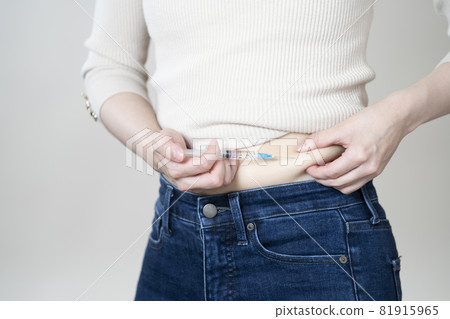 Woman giving insulin injection 81915965