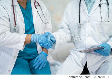 Asian doctor team consult for motivation new normal to treat infection Covid-19 Coronavirus at hospital ward. 81920197