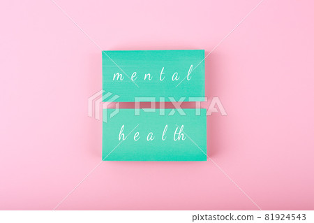 Mental health text written on blue blocks on pastel pink background Mental health text written on blue blocks on pastel pink background 81924543