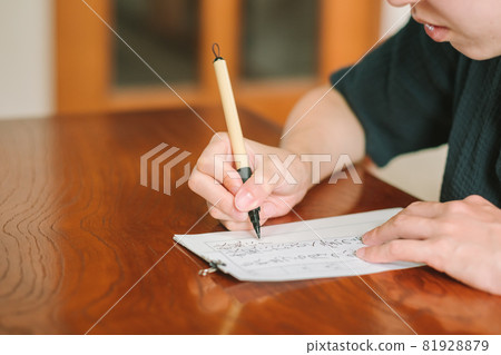 Japanese woman practicing calligraphy, hard brush, brush pen Japanese woman practicing calligraphy, hard brush, brush pen 81928879
