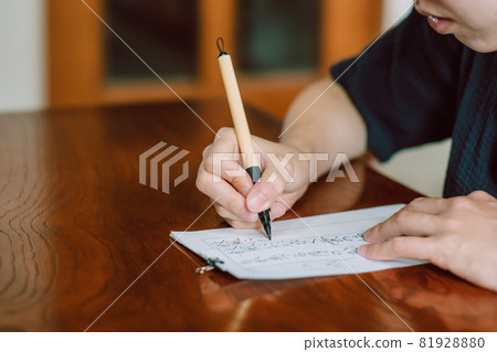 Japanese woman practicing calligraphy, hard brush, brush pen Japanese woman practicing calligraphy, hard brush, brush pen 81928880
