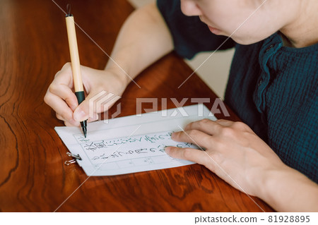 Japanese woman practicing calligraphy, hard brush, brush pen Japanese woman practicing calligraphy, hard brush, brush pen 81928895
