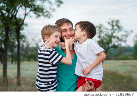 Loving father with two sons outdoors Loving father with two sons outdoors 81929667