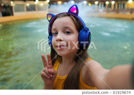 Schoolgirl preteen resting at dusk by fountain Schoolgirl preteen resting at dusk by fountain 81929674