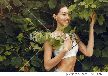 Woman in a sports clothes at the summer park 81932636