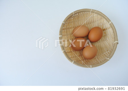 4 red eggs in a colander on a white background 81932691