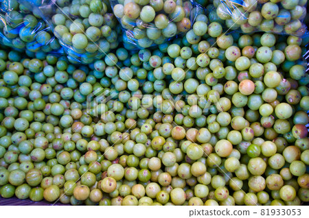 Fresh green Amla (Indian gooseberry) fruit from the local market. 81933053