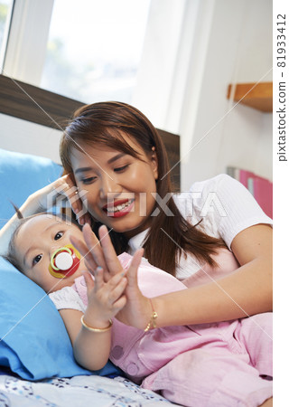 Young Woman Looking at at Little Daughter Young Woman Looking at at Little Daughter 81933412