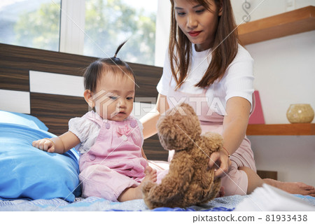 Mother and Daughter Playing with Toy 81933438
