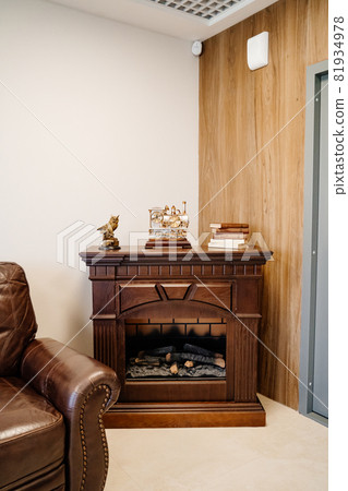 brown decorative fireplace in the office. classic interior brown decorative fireplace in the office. classic interior 81934978