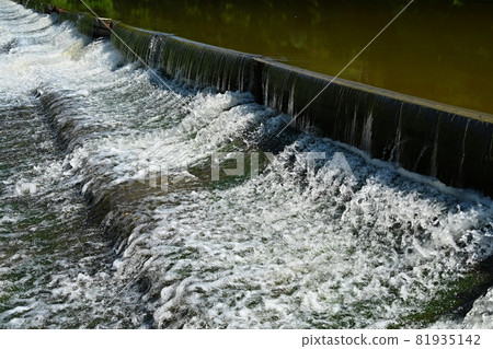 Sluice on the river. Beautiful outdoor nature with running water. 81935142