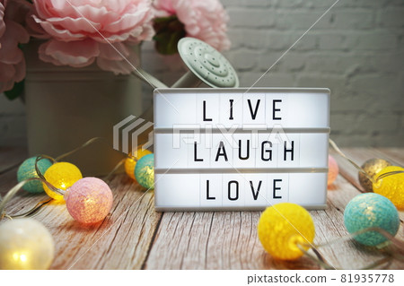 Live Laugh Love text on lightbox on wooden background Live Laugh Love text on lightbox on wooden background 81935778