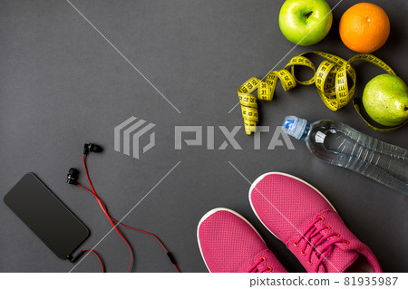 Workout plan with fitness food and equipment on gray background, top view Workout plan with fitness food and equipment on gray background, top view 81935987