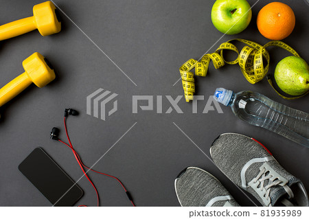 Sports accessories for fitness on the dark floor. Healthy lifestyle concept. Sports accessories for fitness on the dark floor. Healthy lifestyle concept. 81935989