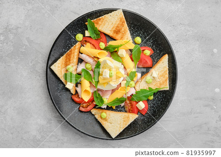 Top view of pieces of toast, ham, boiled egg, cheddar and tomato 81935997