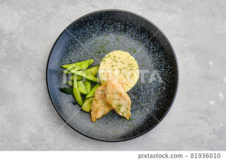 Top view of fried zander fillet with mashed potatoe and pickled cucumber Top view of fried zander fillet with mashed potatoe and pickled cucumber 81936010