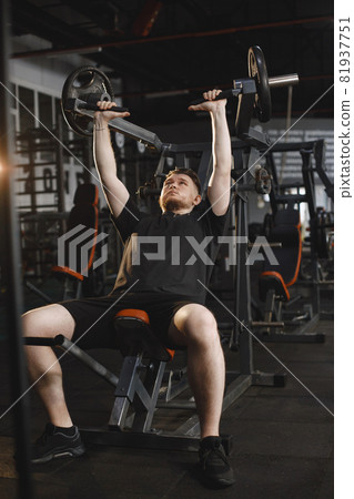 A handsome man is engaged in a gym A handsome man is engaged in a gym 81937751