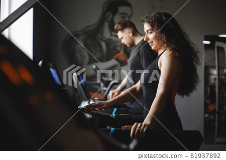 Woman is engaged in a gym with coach 81937892