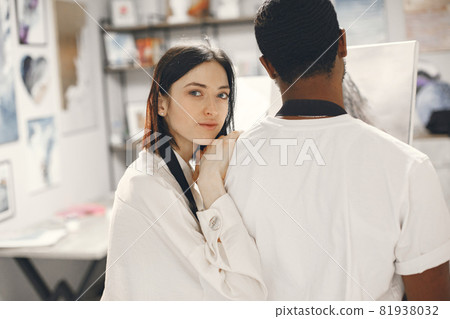 Mixed couple painting picture in workshop Mixed couple painting picture in workshop 81938032