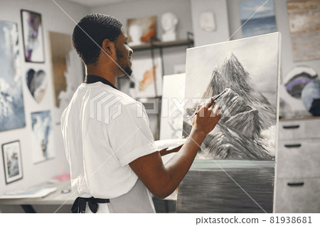 Young African-American artist painting picture in workshop 81938681