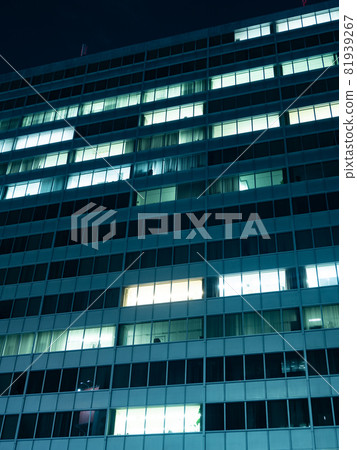 Office building window lights at night 81939267