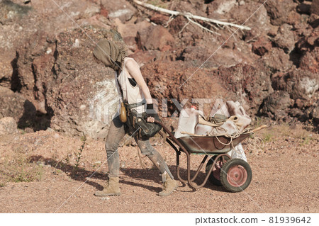 Refugee carrying a cart outdoors Refugee carrying a cart outdoors 81939642