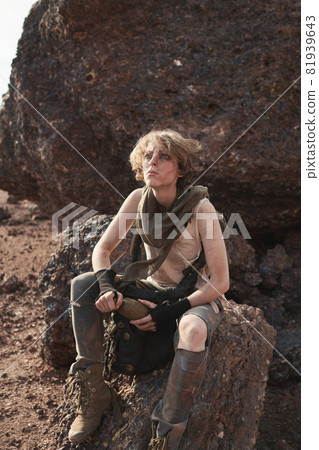 Woman sitting on the rock outdoors Woman sitting on the rock outdoors 81939643