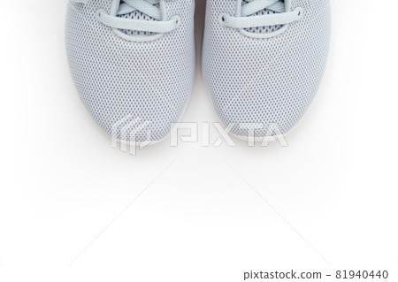 part of gray sports sneakers on a white background. adidas 81940440