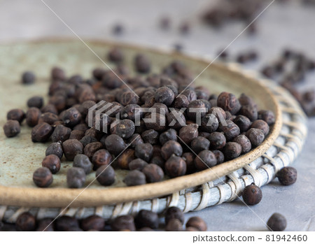 Plate of dry black chickpea on grey table closeup Plate of dry black chickpea on grey table closeup 81942460