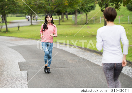 Two women passing each other by jogging Two women passing each other by jogging 81943074