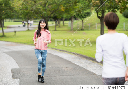 Two women passing each other by jogging Two women passing each other by jogging 81943075