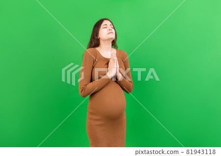 cute pregnant woman praying on colored background isolated cute pregnant woman praying on colored background isolated 81943118
