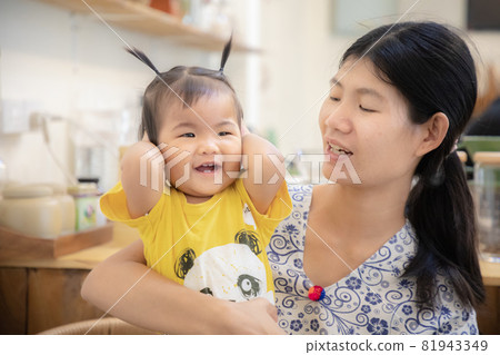 Portrait of cute Asian baby girl and mom at home Portrait of cute Asian baby girl and mom at home 81943349