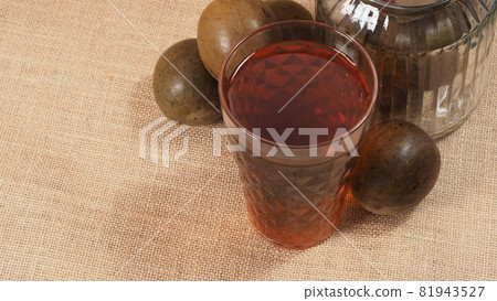 Monk fruit or Luo Han Guo. Dried fruits for healthy sweetener drink. Natural herbal remedy and glass bottle background. Monk fruit drink for who concern health and sugar substitute. 81943527